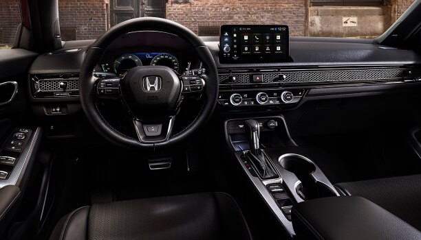 Interior panoramic view of the windshield on a Hatchback parked in front of brick wall in an old warehouse district.
