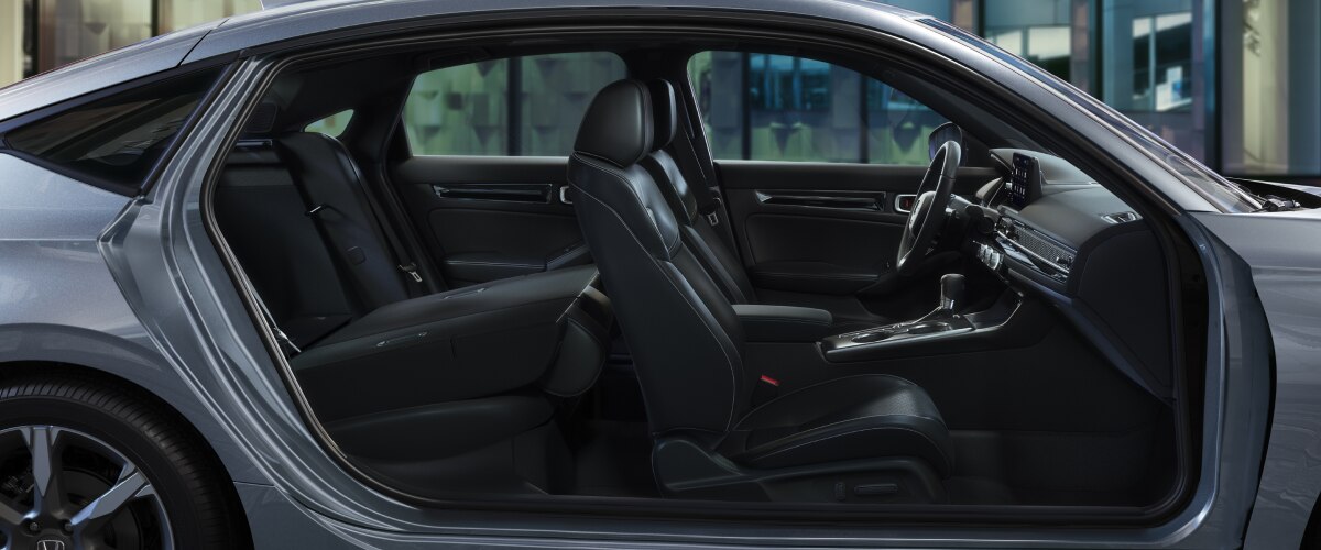 Side view of hatchback with door open at night.