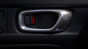 Closeup of interior door handle and lock. 