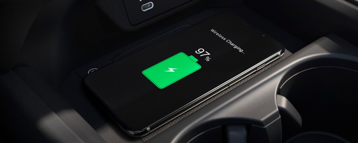 Closeup of phone charging on wireless charging pad.