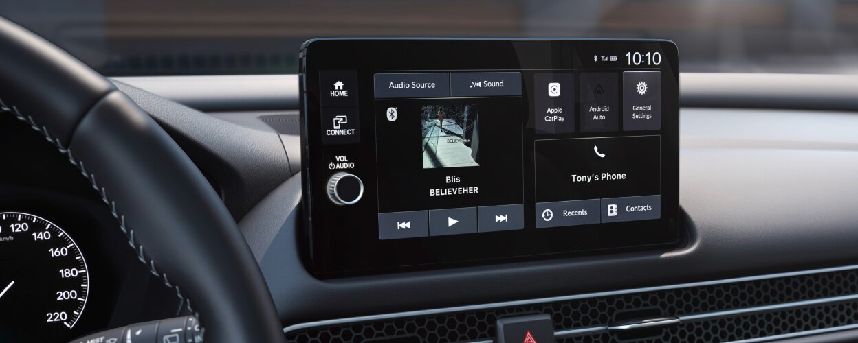 Panoramic view of steering wheel and dashboard. 
