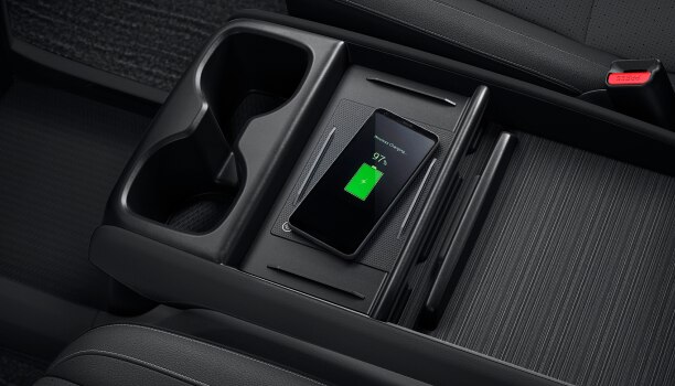 Bird’s eye view of phone charging on pad in centre console.