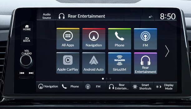 Hand pressing centre console touchscreen button.