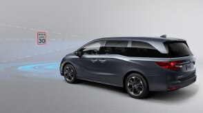 3/4 rear view of Odyssey in front of a speed sign. Blue sensor waves and lines emit from the front.