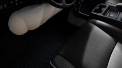 Closeup of inflated airbag under steering wheel.