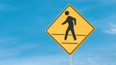 Closeup of “pedestrian crossing” sign.