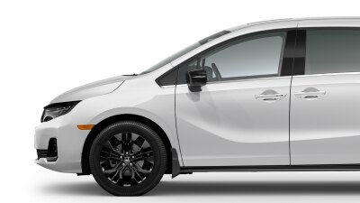 Side view of front of white Odyssey on white space, showcasing the front wheel.