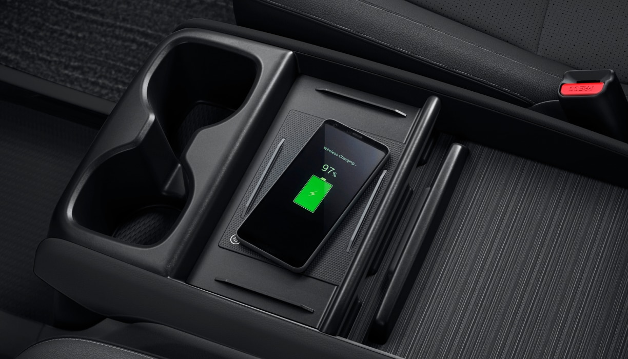 Bird’s eye view of phone charging on pad in centre console.