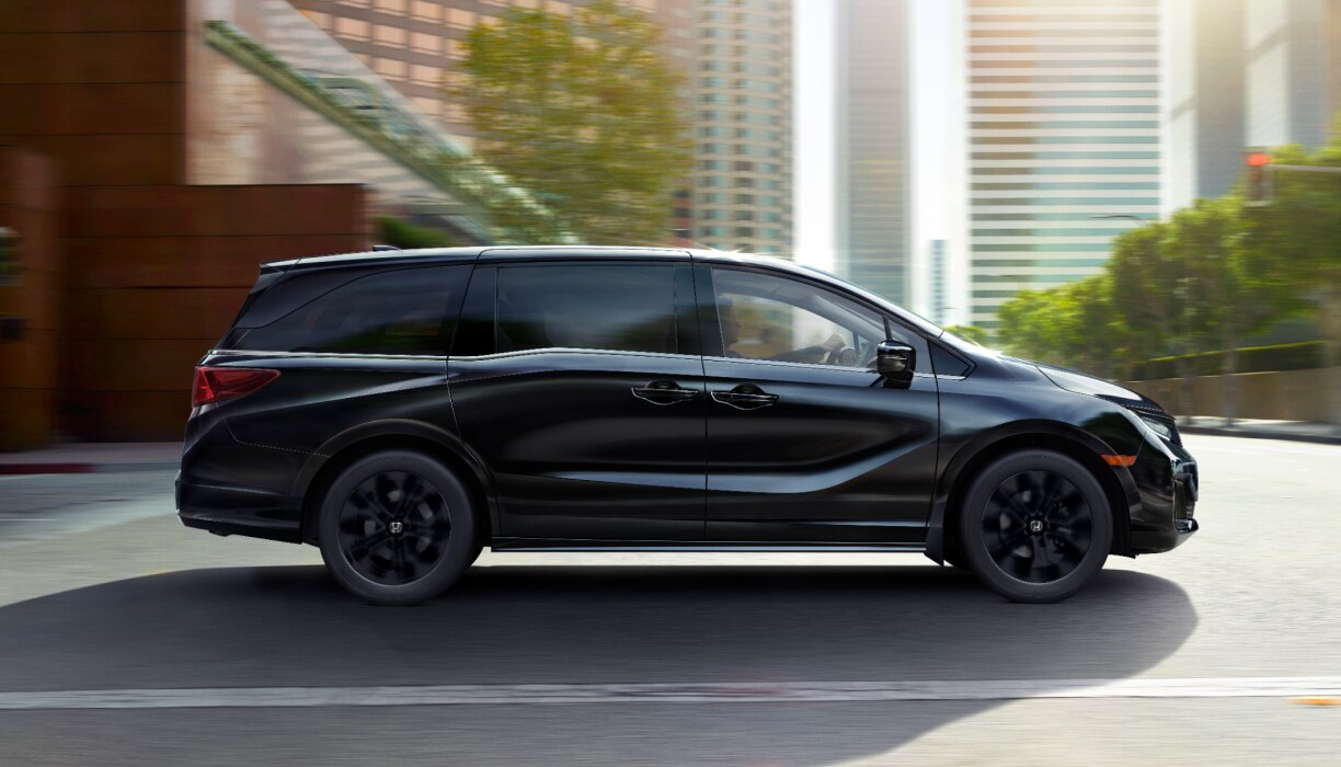 Side view of an Odyssey driving in the city.