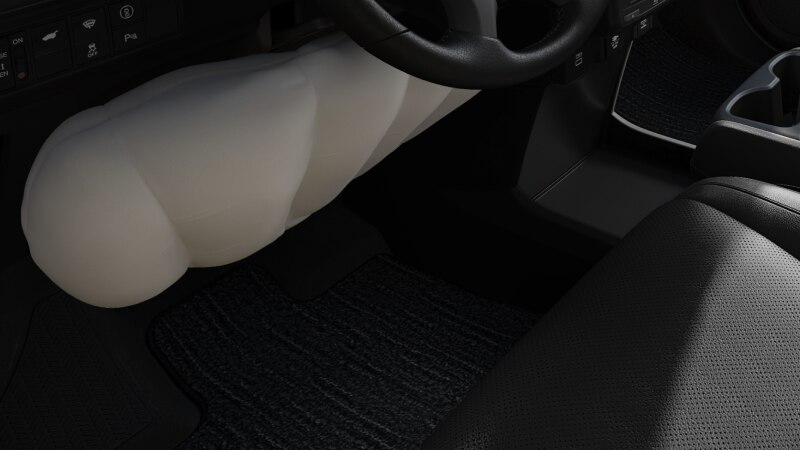 Closeup of inflated airbag under steering wheel.