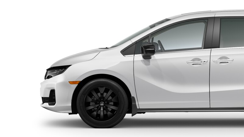 Side view of front of white Odyssey on white space, showcasing the front wheel.