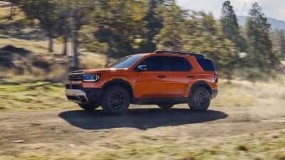 Side view of an orange Passport is in an outdoor space. 