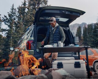 Image of a person camping with their Passport.