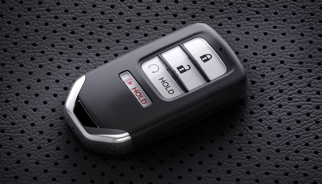 Closeup of key fob sitting on perforated seat.