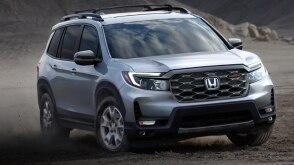 3/4 front view of grey Passport off-roading in desert.