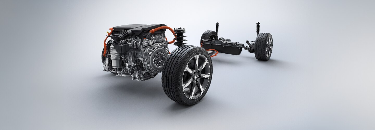 An unbuilt Honda showing only the engine and wheels is depicted against a grey neutral background.  
